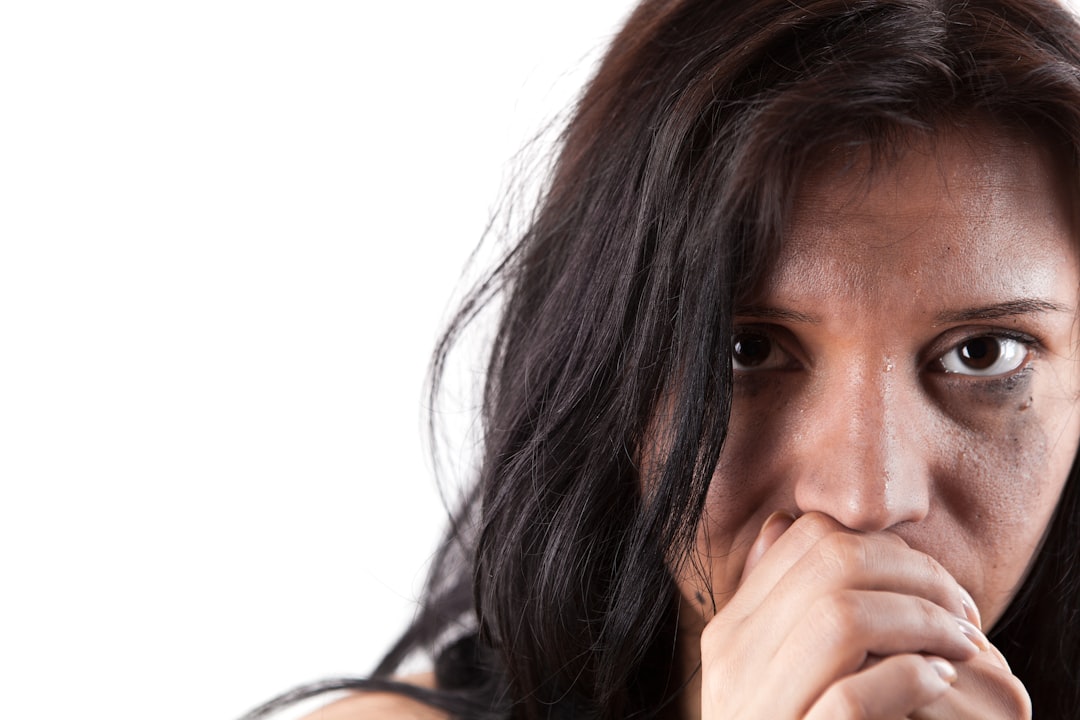 A woman covering her mouth with her hands