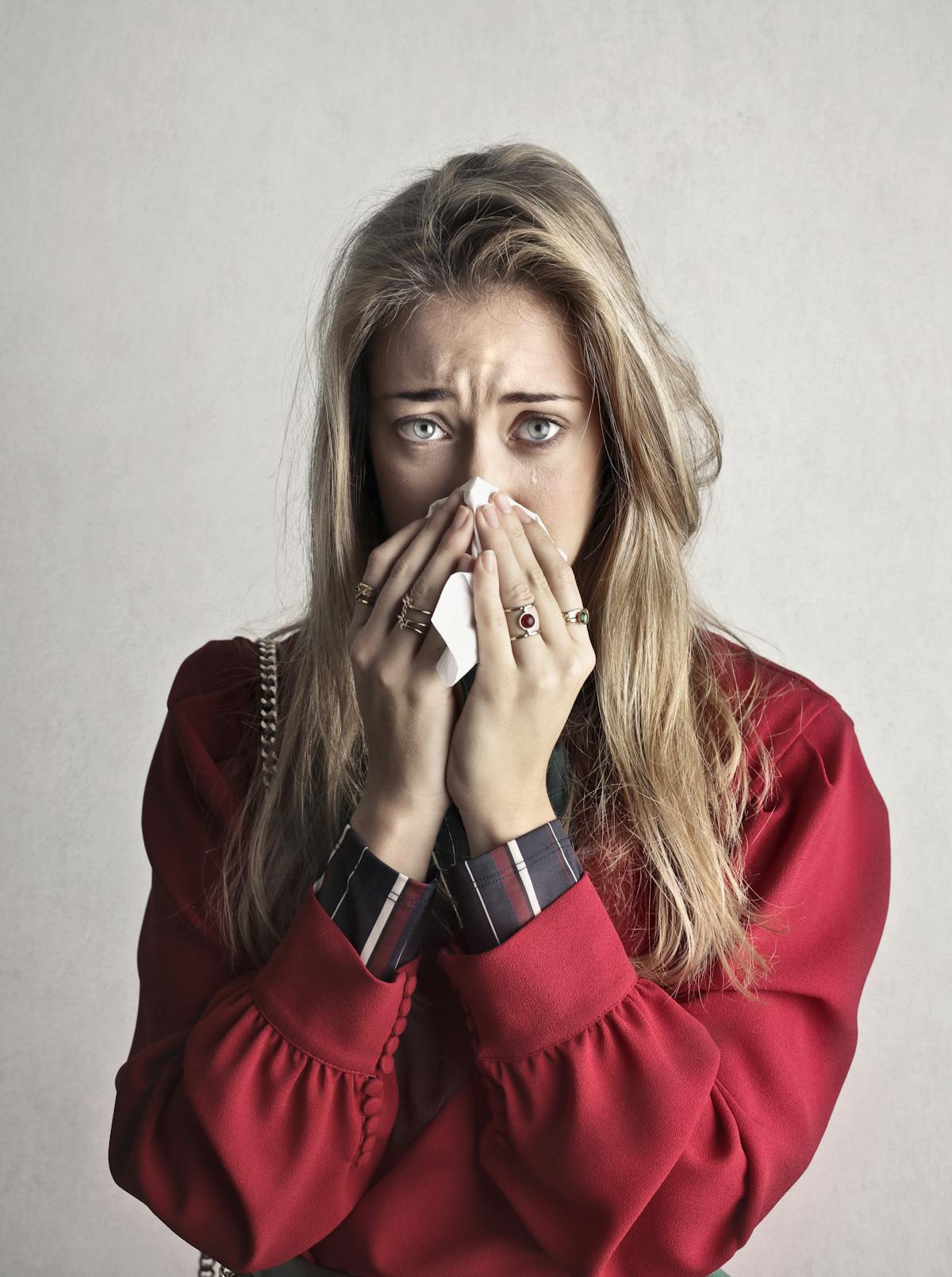 Person holding a tissue, dealing with congestion