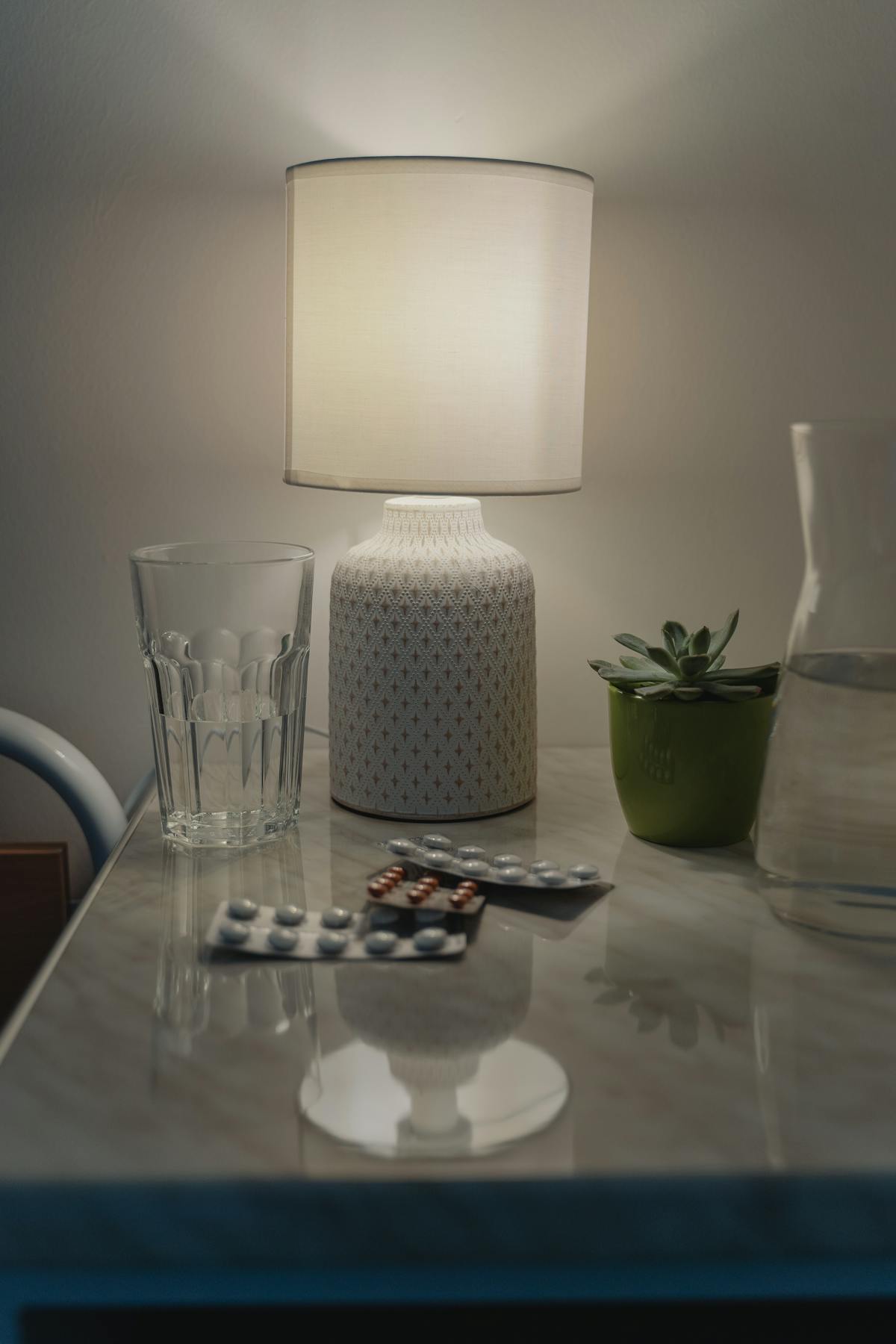 Glass of water resting on a bedside table