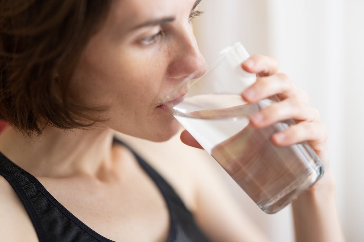 Person drinking water from a glass
